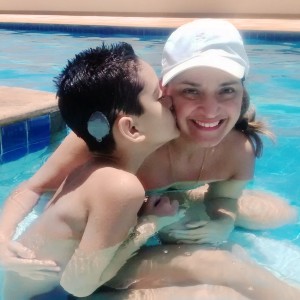 Alexandre and Deborah in pool: supporting a child with hearing loss