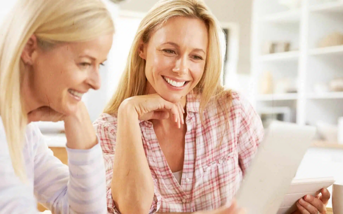 Two women looking at a screen