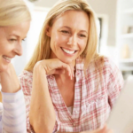 Two women looking at a screen