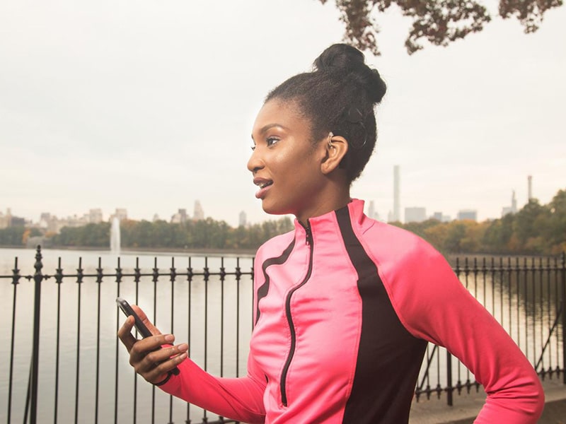 Woman running while wearing SONNET 2 audio processor