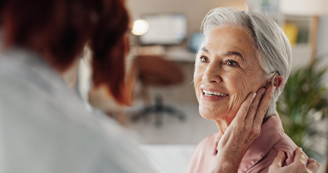 Woman at hearing assessment receiving hearing aid
