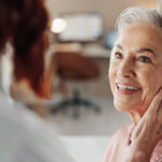 Woman at hearing assessment receiving hearing aid