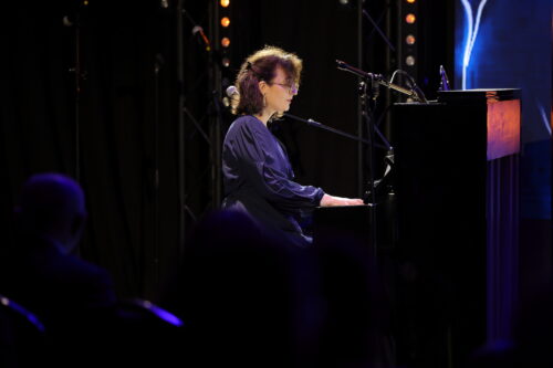 A CI user playing the piano at the Beats of Cochlea festival 2025