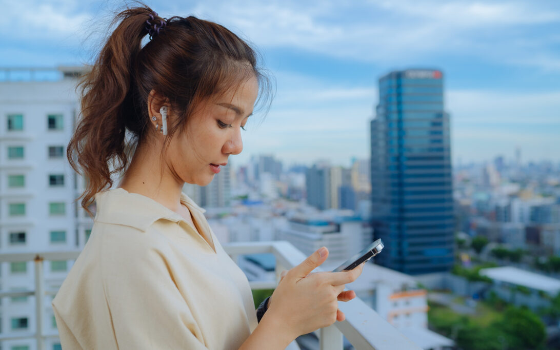 A woman using Apple Airpods as hearing devices