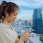 A woman using Apple Airpods as hearing devices