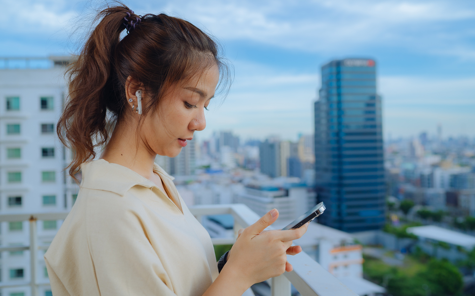 A woman using Apple Airpods as hearing devices