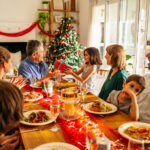 A family sitting around a table, celebrating the holidays