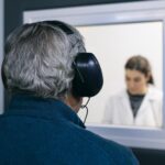 Doctor giving instructions to patient during a hearing test