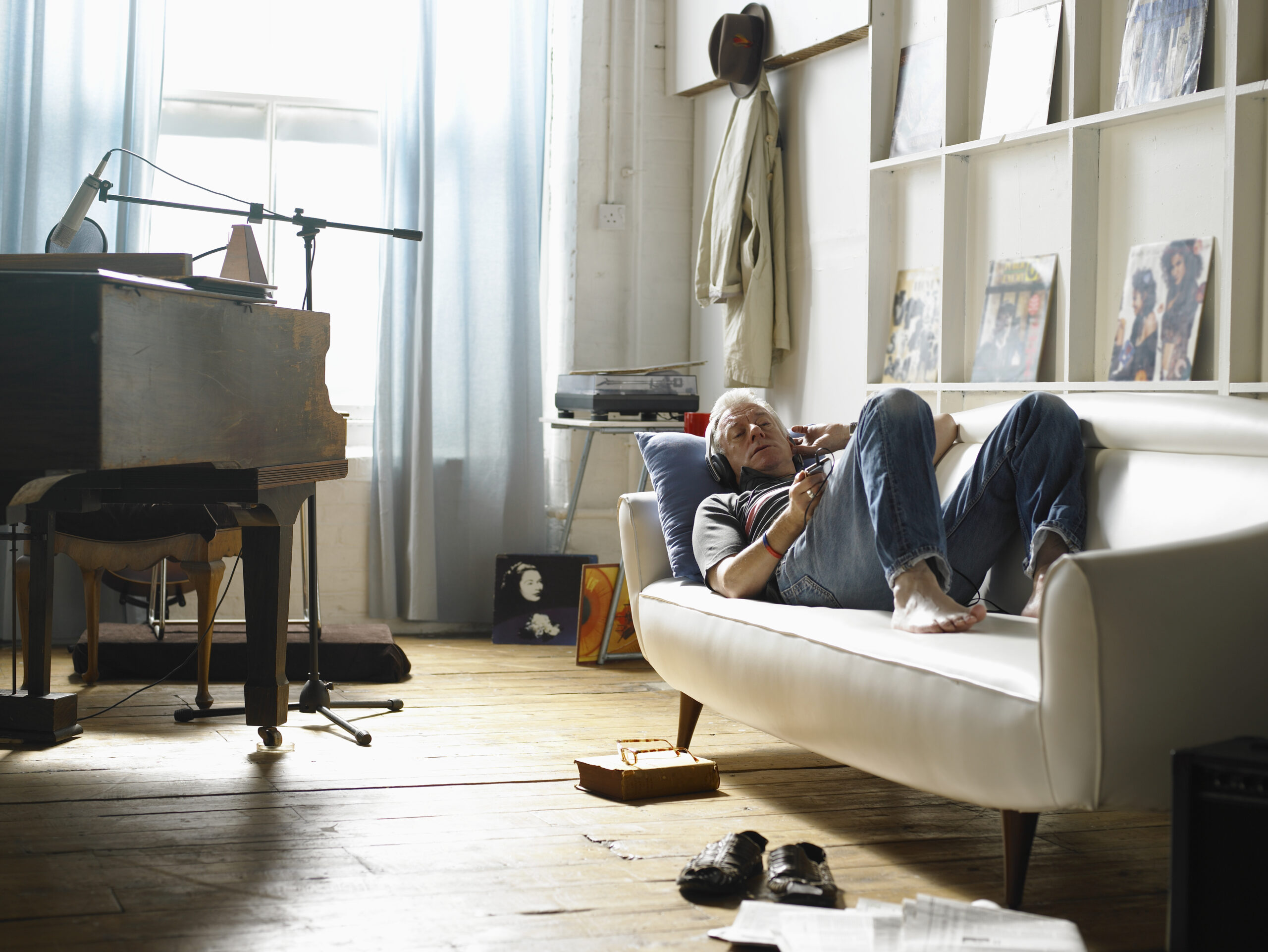 kanepede uzanmış müzik dinleyen yetişkin adam