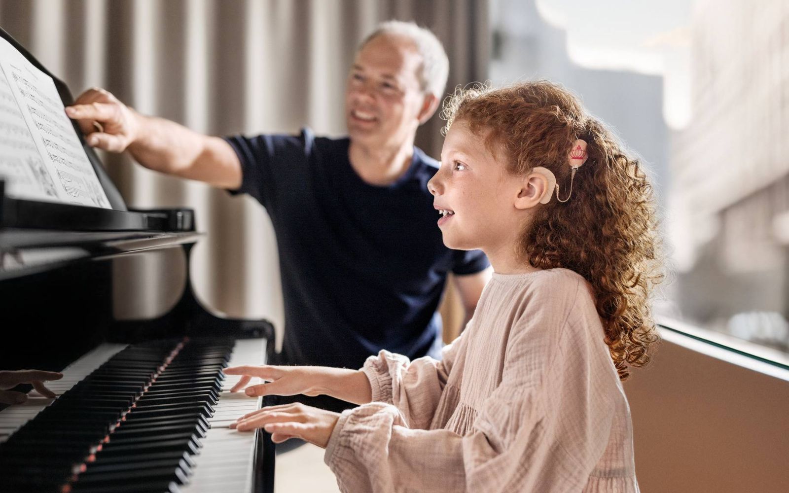 Girl with audio processor play the piano.
