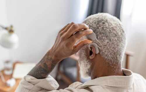 A man adjust the coil of his audio processor