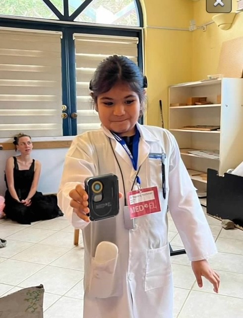 Chanelle holding a cochlear implant
