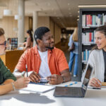 A CI user talking to his friends in a library