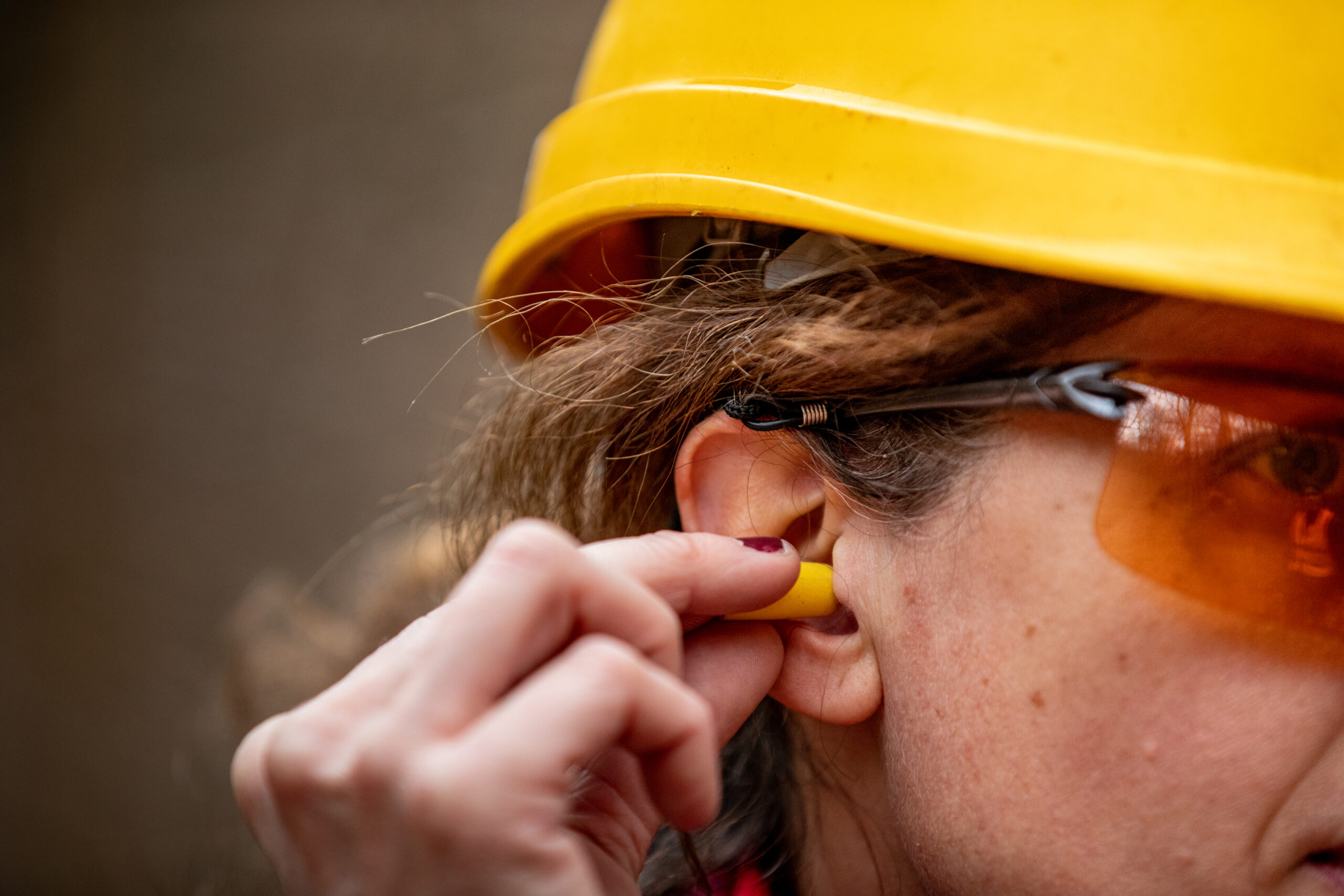 Person using ear protection to reduce the risk of noise-induced hearing loss.